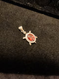 Turtle pendant. Red is cubic zerconia. Outer ring moissanite.